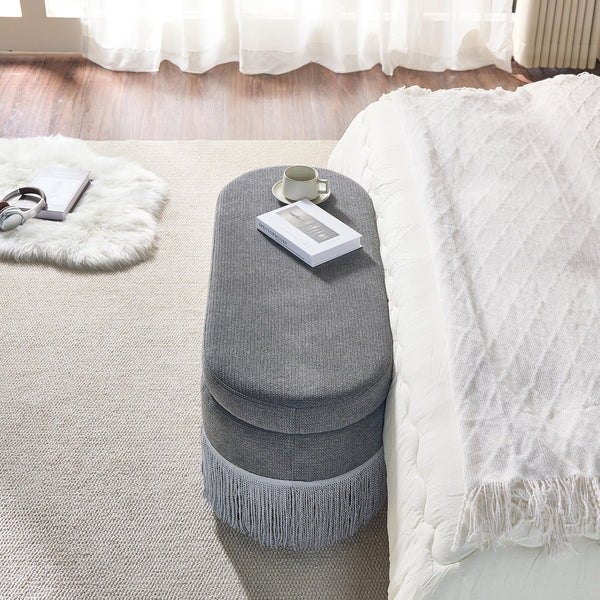 Oval Upholstered Storage Ottoman With Fringe Trim & Lift Top Lid